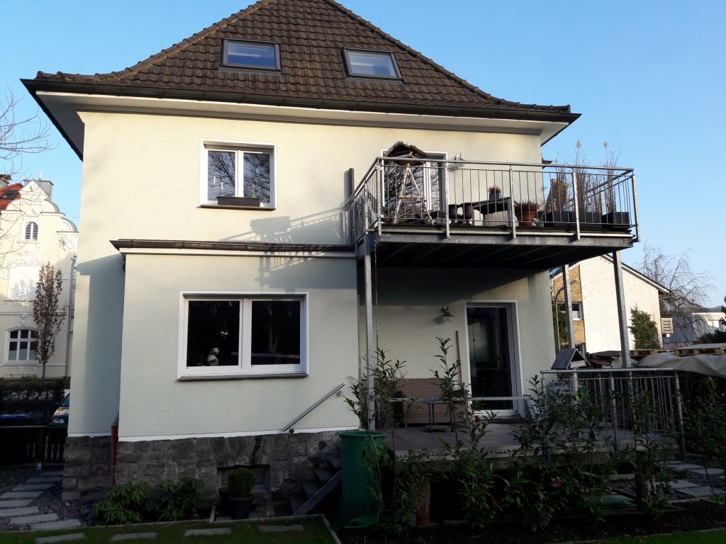 Weißes saniertes Haus mit Balkon